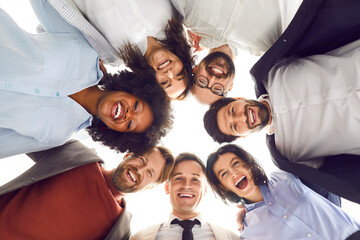Bottom view group portrait of a happy multinational business team smiling and looking at the camera...