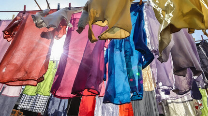A line of clothes hanging on a clothesline