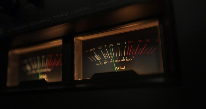 Analog VU meters on classic hi-fi reel-to-reel tape recorder. Retro sound level meter decibel meter in studio, vintage audio equipment.