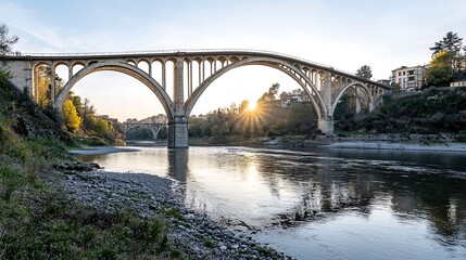 Fototapeta premium A stunning view of a stone and metal bridge illuminated by the golden rays of the setting sun, surrounded by a peaceful landscape. The photograph highlights the bridgeâ€™s dynamic lines and textures,