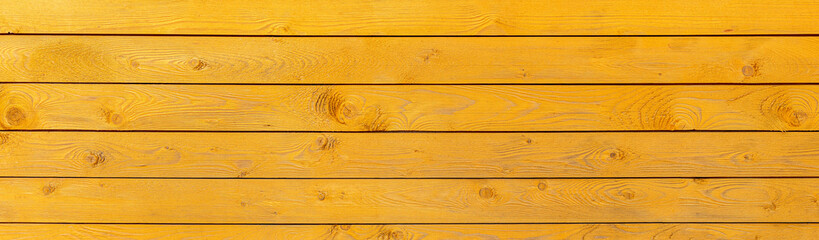 Light yellow wood texture with a horizontal long plane, the surface of a building wall or fence. background for design