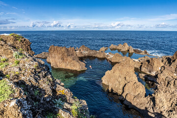 Fototapeta premium Serene Rocky Coastline Featuring Natural Pool and Majestic Ocean Views, Porto Moniz, Madeira