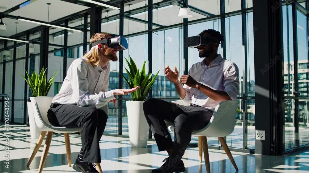 Leinwandbilder Two individuals engage in a virtual reality session in a modern office setting with large windows and plenty of natural light