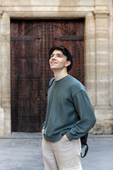 Obraz premium Young tourist looking up and admiring the beauty of historical architecture