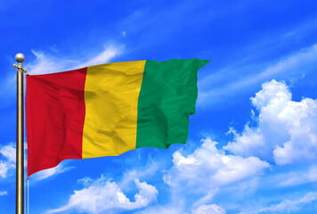Guinea National Flag Waving Against Clear Blue Sky