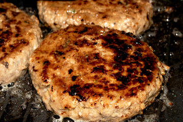 Frying Burgers Beef Meat in a Pan with oil Cooking