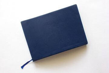 Blue closed notebook. Isolated on white background.