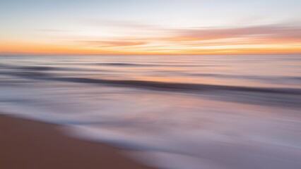 Obraz premium arafed view of a beach with waves and a sunset,