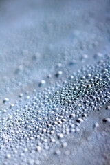 Close Up of Condensation  Water Liquid Bubbles and Drips on Glass from Rain Abstract Background