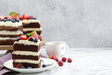 Piece of delicious chocolate sponge cake with berries served on white table. Space for text