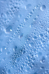 Close Up of Condensation  Water Liquid Bubbles and Drips on Glass from Rain Abstract Background