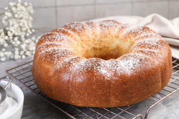 Freshly baked sponge cake on grey table, closeup