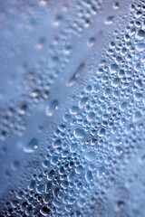 Close Up of Condensation  Water Liquid Bubbles and Drips on Glass from Rain Abstract Background