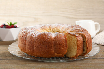 Freshly baked sponge cake served on wooden table, closeup