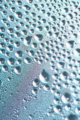 Close Up of Condensation  Water Liquid Bubbles and Drips on Glass from Rain Abstract Background