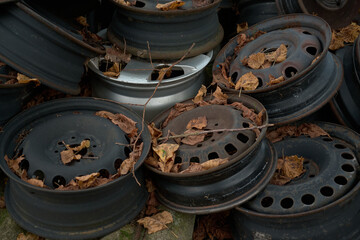 A sad mountain of old rusty wheel rims