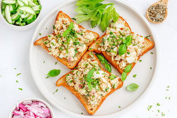 Open Faced Egg Sandwich Garnished with Fresh Basil and Peppers Directly Above Photo