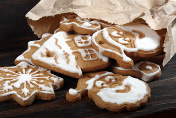 Christmas gingerbread cookies with white icing in a paper bag on the table. holiday cookies. close up