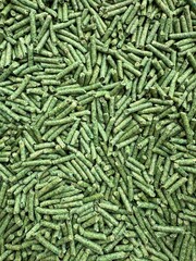 Tofu Litter Pellets in green palette. Pieces of Flushable Clumping Fast Drying Tofu Cat Ultra Absorbent Litter. Premium eco litter, soluble in water.