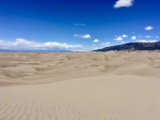 sand dunes with mountain in the background