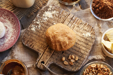 Dough made of whey protein powder, maple syrup and peanut butter - ingredient for homemade healthy protein chocolate bars