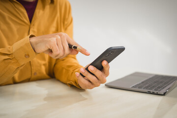 A focused man works diligently in his office, reviewing numerous accounting documents on his desk. His goal is to ensure accuracy and precision, avoiding errors in critical financial data.