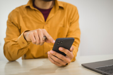 A focused man works diligently in his office, reviewing numerous accounting documents on his desk. His goal is to ensure accuracy and precision, avoiding errors in critical financial data.