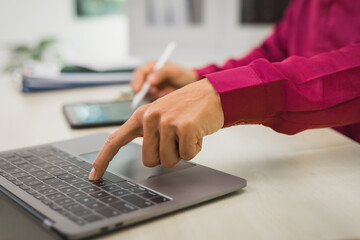 A focused man works diligently in his office, reviewing numerous accounting documents on his desk. His goal is to ensure accuracy and precision, avoiding errors in critical financial data.