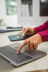 A focused man works diligently in his office, reviewing numerous accounting documents on his desk. His goal is to ensure accuracy and precision, avoiding errors in critical financial data.
