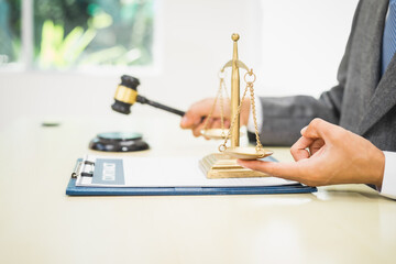 Male lawyer diligently examines documents placed on his desk, demonstrating his professionalism and dedication to finding legal truth, analyzing ideas, and pursuing justice with relentless focus.
