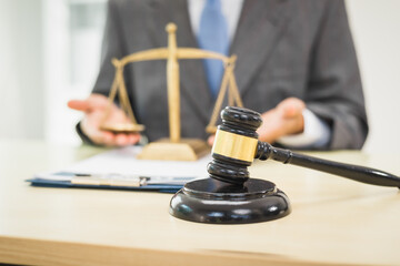 Male lawyer diligently examines documents placed on his desk, demonstrating his professionalism and dedication to finding legal truth, analyzing ideas, and pursuing justice with relentless focus.