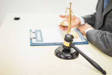 Male lawyer diligently examines documents placed on his desk, demonstrating his professionalism and dedication to finding legal truth, analyzing ideas, and pursuing justice with relentless focus.