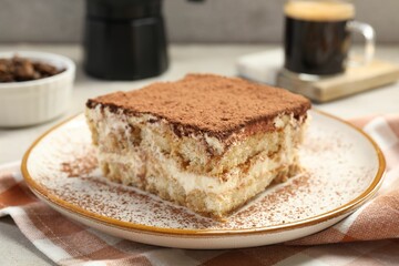 Piece of tasty tiramisu on table, closeup