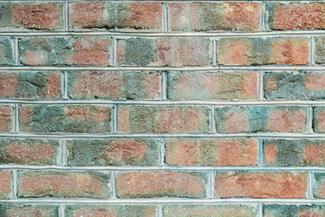 The wall of the building is made of dark, red to brownish clinker brick with various alternating...