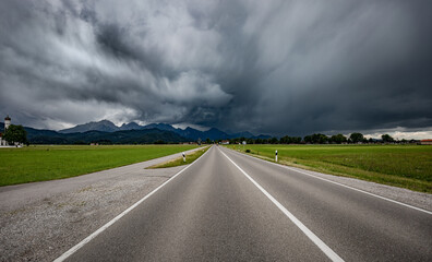 Road leading into a storm - Forggensee and Schwangau, Germany Bavaria