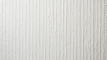 A textured white wall features vertical lines that create a modern aesthetic in this interior space, perfect for minimalist design. The smooth surface enhances the room's brightness