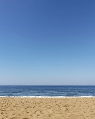 Fototapeta premium Serene Seascape Tranquil Ocean Beach with Clear Blue Sky and Golden Sand