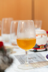 A glass  of French apple cider on table, from region cider called Normandy.  Most ciders are made from a blend of apple varieties, classified under 5 different types: acidic, sweet, sour, sweet-sour.
