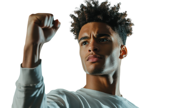 A Young Man Celebrating Success with a Joyful Expression of Triumph for Use in Positive Messaging and Inspirational Content.