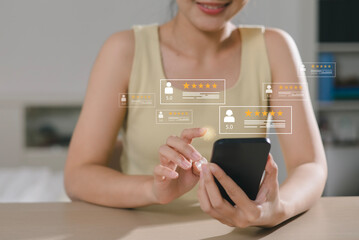 Close up of Asian customer. User presses with hand and five star icon on display screen for positive customer feedback, testimonials and confirmation. User comments and suggestions to make a review.