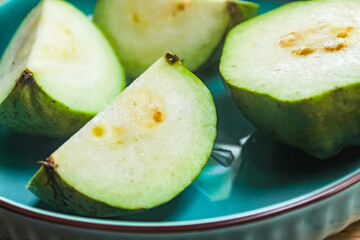 several pieces of guava in a plate