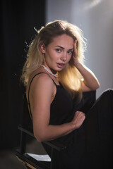 An Elegant Woman in a Beautiful Black Dress Posing Elegantly with Grace and Charm