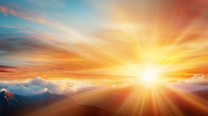 Fototapeta premium A bright sun shining through the clouds over a mountain range