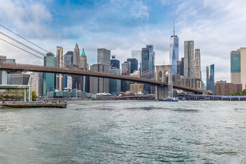A view from the shore of  the East river towards the Brooklyn bridge and Manhattan in New York, in the fall