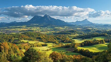 Obraz premium Autumn valley landscape with mountains, forest, fields, and cloudy sky.