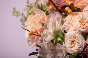 Close-Up of a Floral Bouquet with Sea Buckthorn Branches on Lilac Background