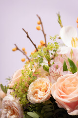 Close-Up of a Floral Bouquet with Sea Buckthorn Branches on Lilac Background