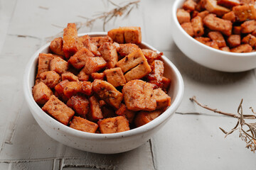 some bowls with marinated tofu cubes