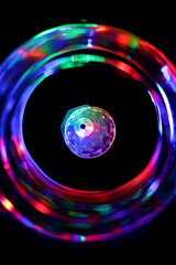 Close up of the colorful party light surrounded by the vortex of blurry colors