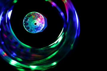 Close up of the colorful party light surrounded by the vortex of blurry colors